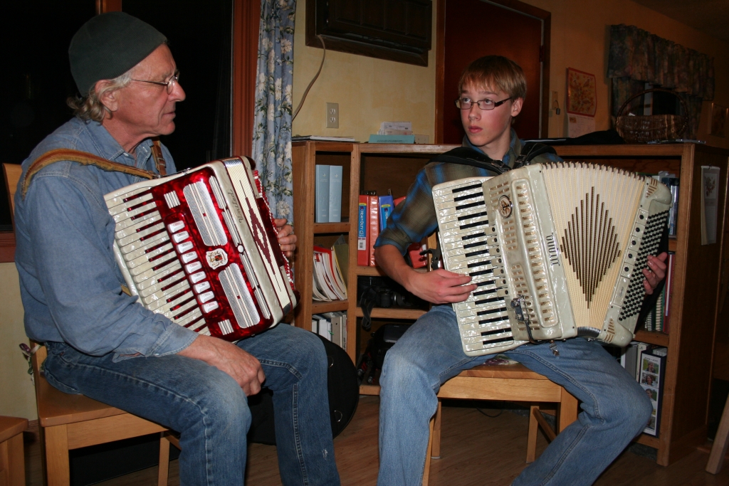 A photo of Master accordionist Chuck Suchy with apprentice Johan Stenslie, both of Mandan, ND playing accordians.