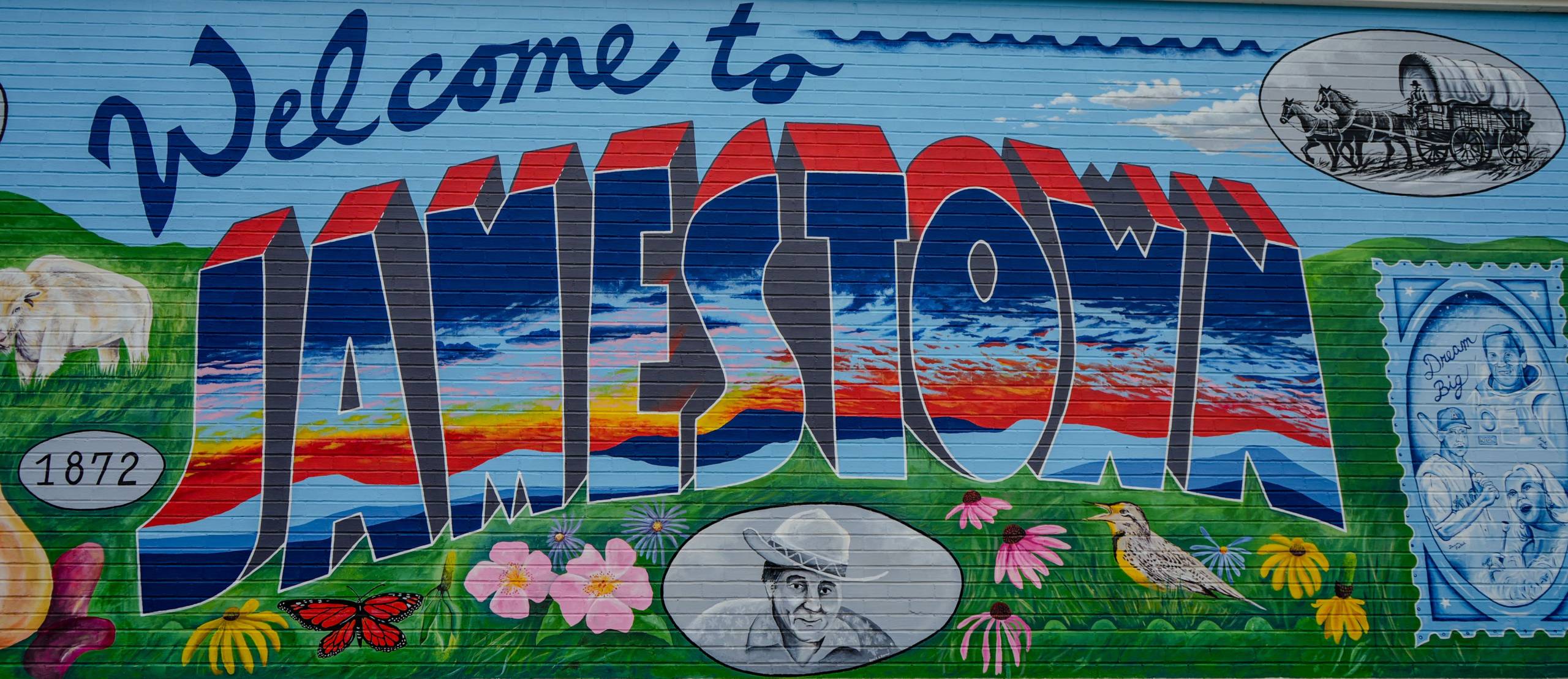 Welcome to Jamestown mural, painted by ND artist Paul Noot, with elements including Native American heritage, famous people such as Louis L'Amour, Peggy Lee, Rick Hieb, and Darin Erstad, and showcasing patriotism and Americana