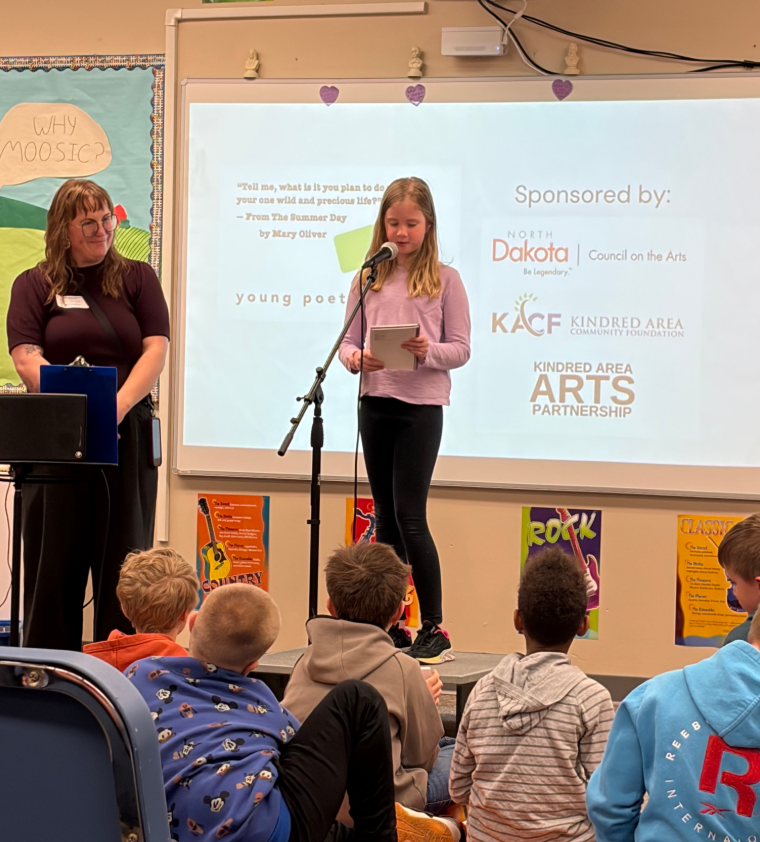 Teaching artist Anna Paige helping Kindred students with a young poets program
