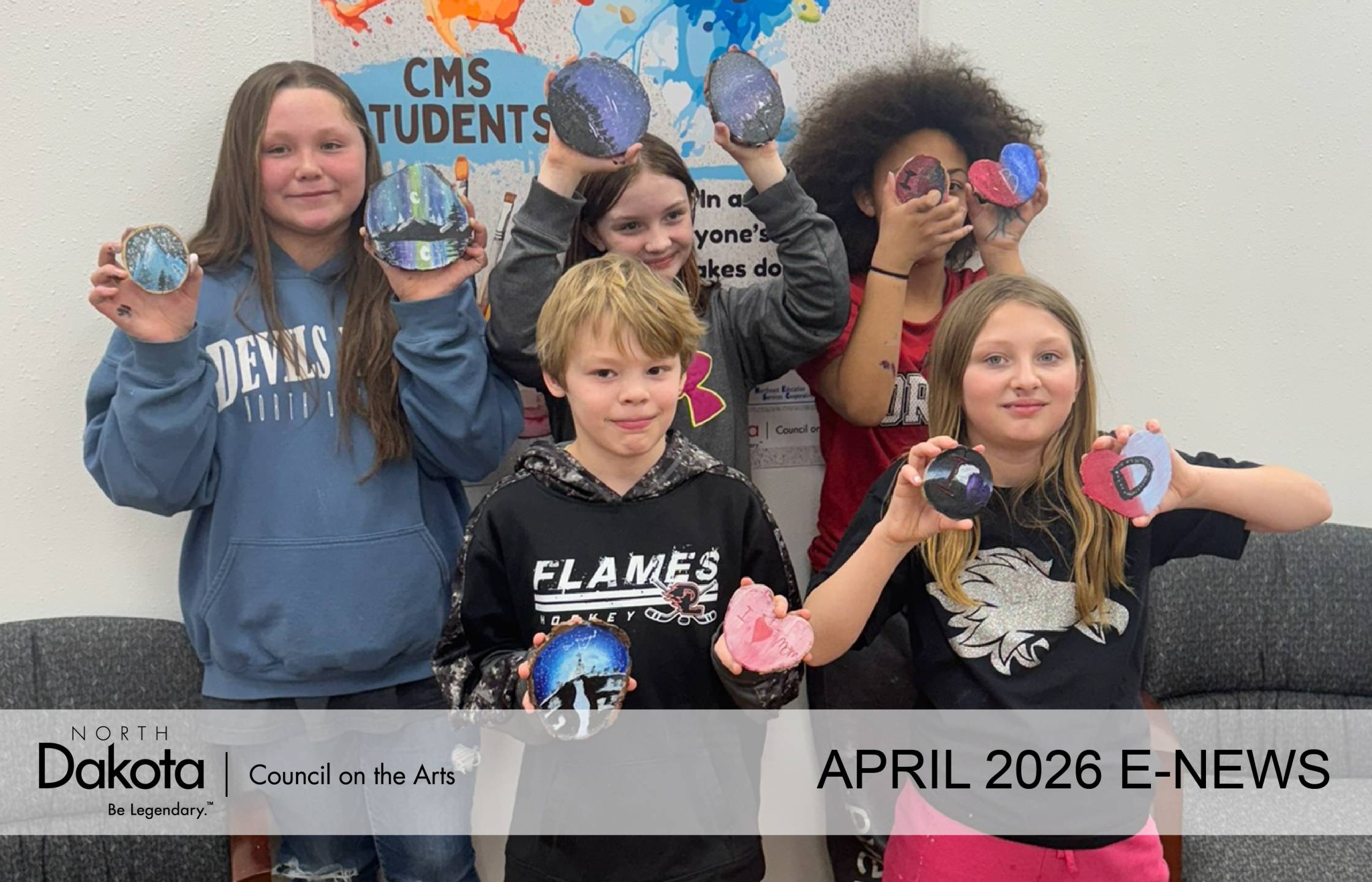 5 Devils Lake middle school students proudly show off their acrylic paintings on rough cut wood round