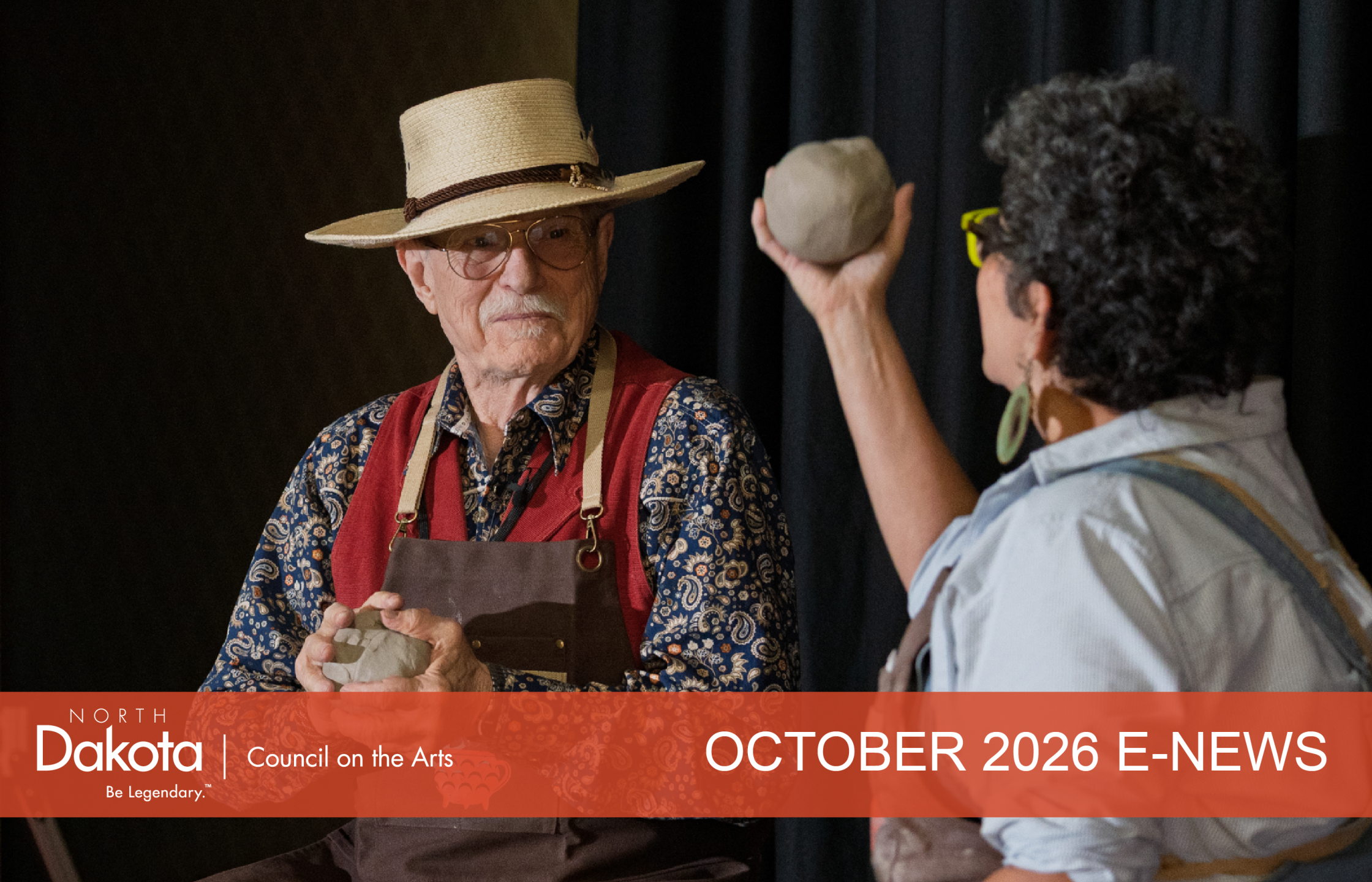 ND artists Walter Piehl and Shelly Sayler holding clay balls on a stage where they will start to throw them on a wheel