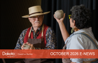 ND artists Walter Piehl and Shelly Sayler holding clay balls on a stage where they will start to throw them on a wheel