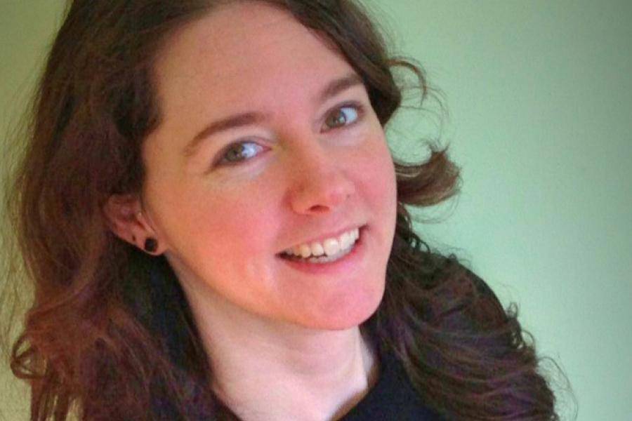 head and shoulders of artist Ali LaRock with thick flowing dark hair, and partial toothy smile that reaches her dark eyes