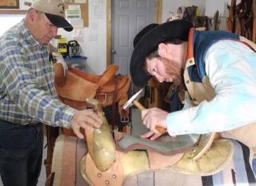 Photo of a master and apprentice working on a saddle