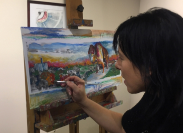 Linda Roesch painting buffalo and scenic background on canvas