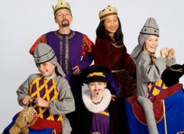 five actors wearing mid-evil costumes including crowns and bright colors