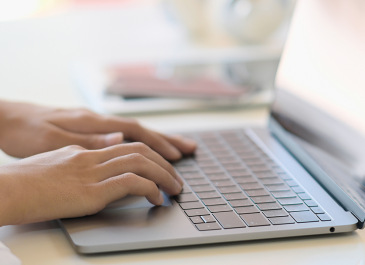 hands typing on laptop