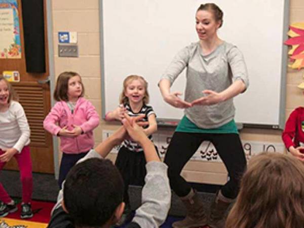 Photo of Northern Plains Dance dancer instructing young children