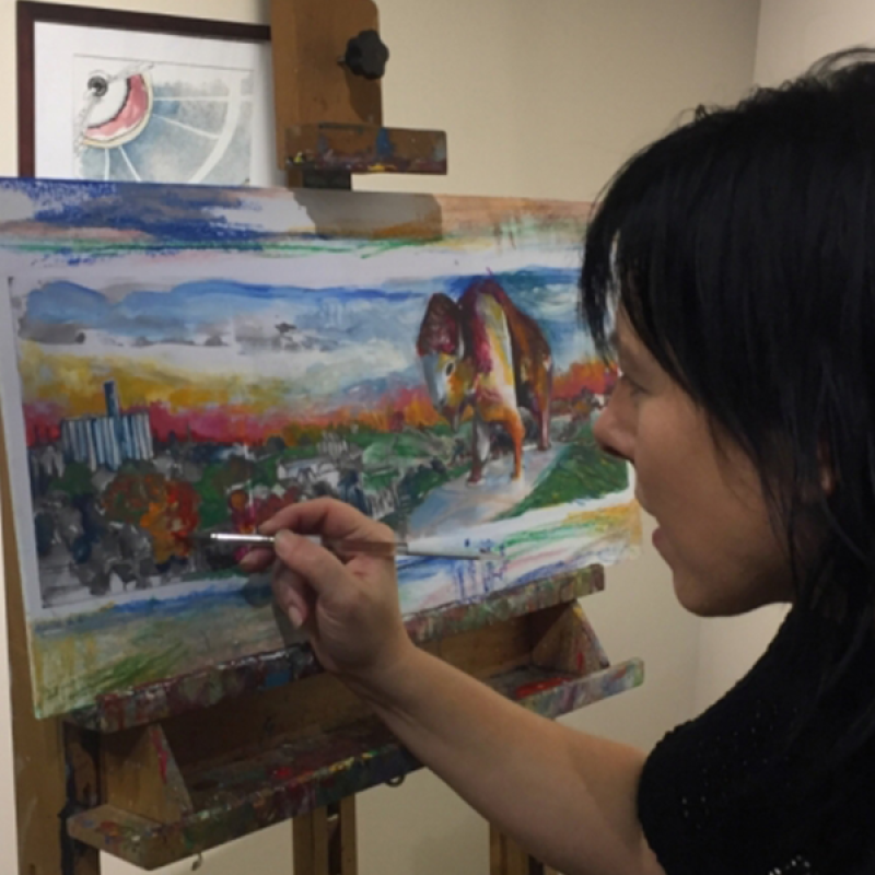 Linda Roesch painting buffalo and scenic background on canvas