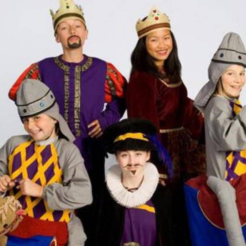 five actors wearing mid-evil costumes including crowns and bright colors