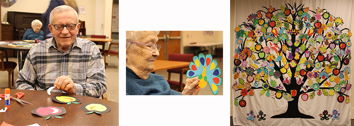 Elders in Jamestown, ND cutting colored paper in shapes to create a tree of life