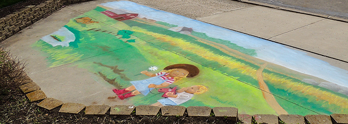 Artist Melissa Gordon sidewalk chalk drawing at Prince of Peace Care Center in Ellendale, ND