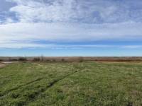 Site for public art installation in Region 3 of North Dakota, showing green grass and blue skies