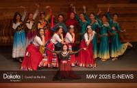 NDCA's May 2025 E-news Header showing a big group of female Chinese dancers in full regalia, posing on a stage