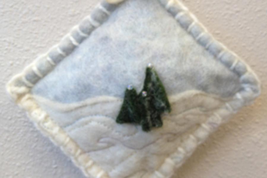 White pillow ornament with tree in center