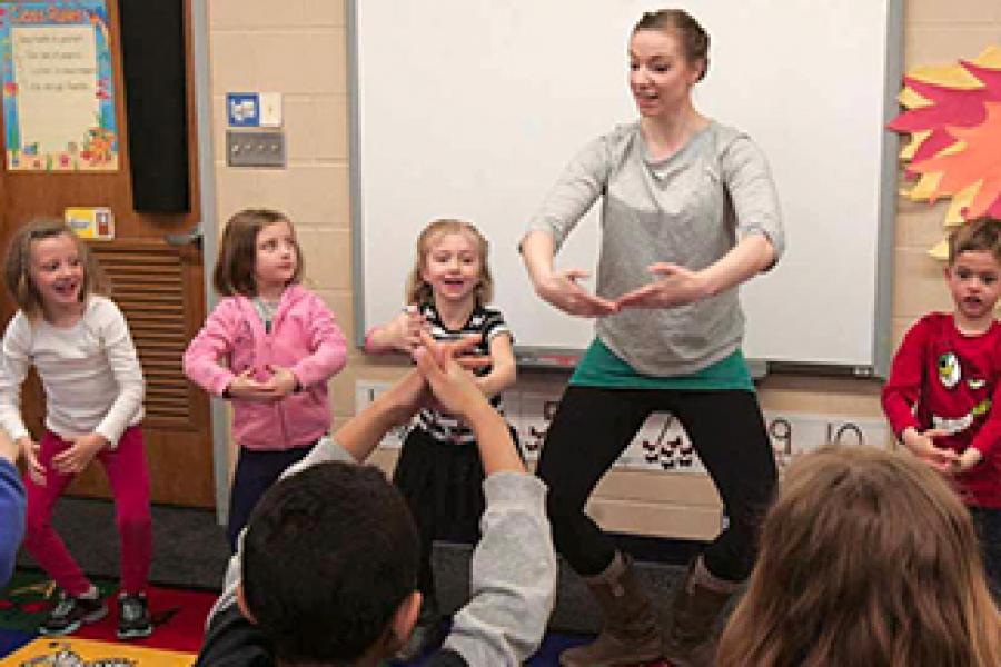 Photo of Northern Plains Dance dancer instructing young children