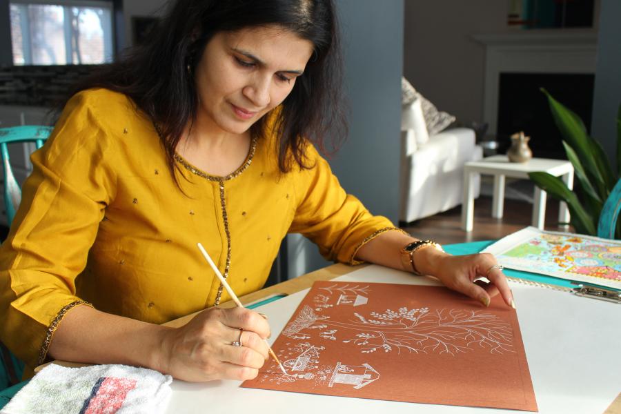 Photo of Shalini Agarwal drawing Warli art