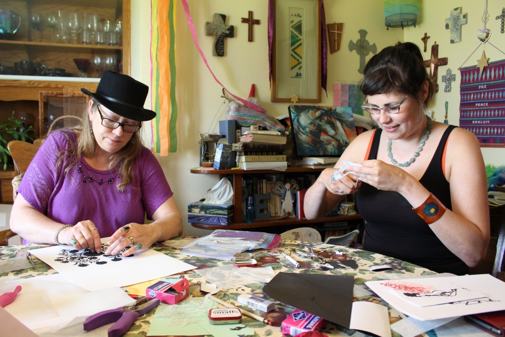 Photo shows Master papercutting artists Meridee Erickson-Stowman, from Tower City teaching apprentice Sabrina Hornung of Jamestown, ND papercutting.