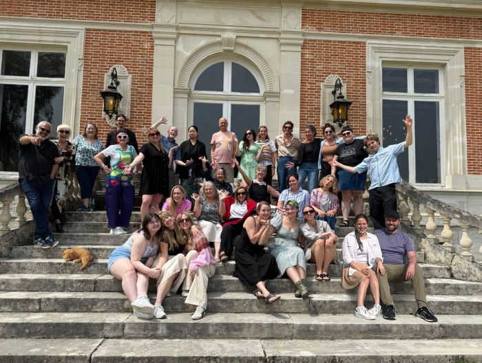 Group of people posing on steps of historical building