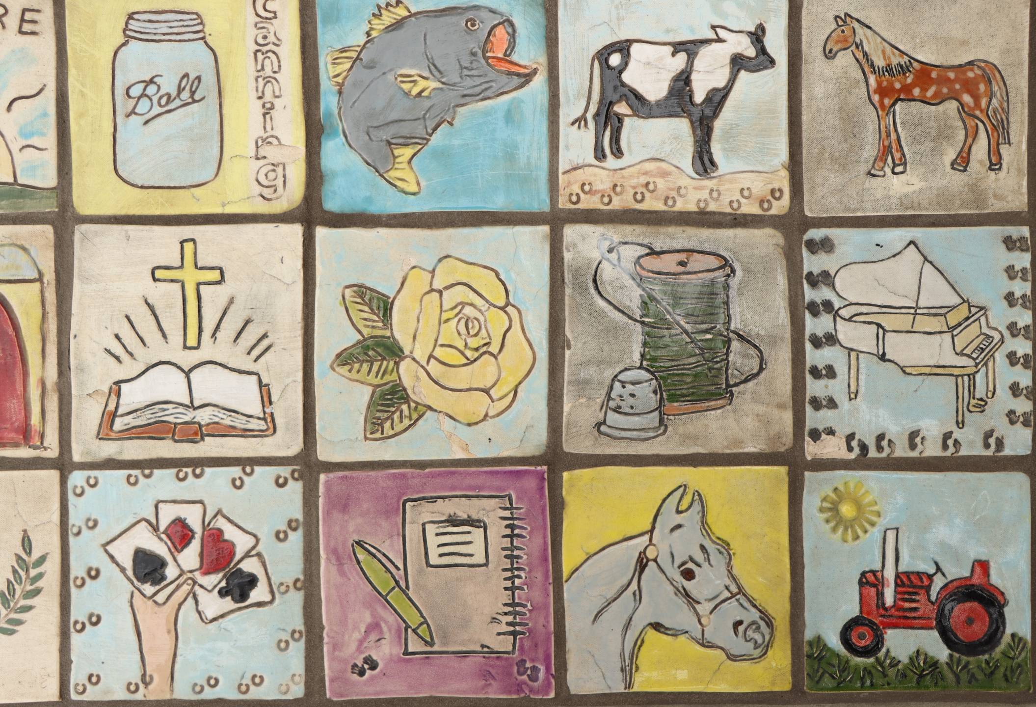 multiple rows of squares, laying on the ground as stepping stones, individually painted by residents of Maryhill Manor