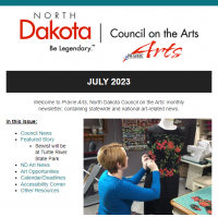 Top screenshot of NDCA Prairie Arts July Newsletter showing the Index and a picture of Cynthia McGuire Theil wearing a long-sleeve teal-blue shirt with short red hair, sewing red roses on a black dress