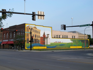 Huge painted mural on side of building in Wahpeton, ND showing what Wahpeton looked like originally with an old building, grainery, church and prairies