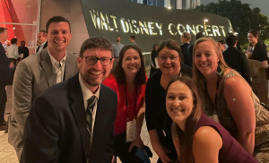 Ellen Fenner and a hand-ful of other small budget orchestra directors pose in front of Walt Disney Symphony Hall 