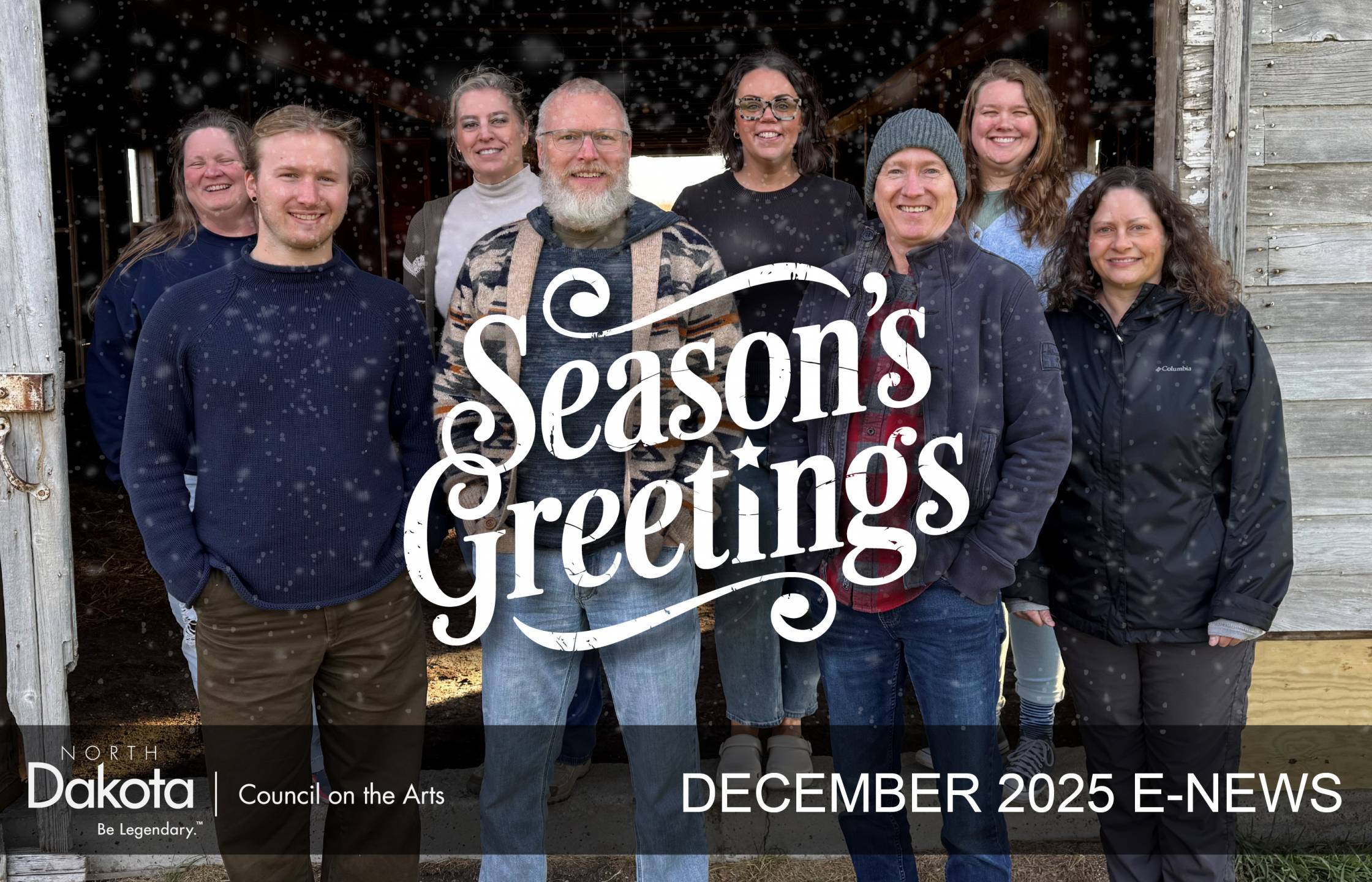 NDCA December 2025 E-News and Season's Greeting's text on top of the 8 employees of NDCA, standing in front of a barn door, wearing warm clothing and smiling
