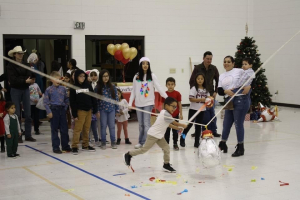 Watford City boy Mishael Vega is breaking La Piñata and children waiting for their turn