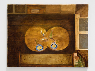Mollie Douthit 2023 oil on linen panle painting called The goal. Overhead view of a room with a wooden floor, walls, two round tables, a bed and a double-paned window on the side. There are dishes on the table and a small green plant in the corner. Whimsical and earthy.