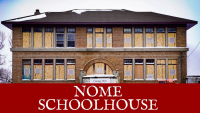 dilapidated 3-story 1916 Nome Schoolhouse with dead trees and broken windows