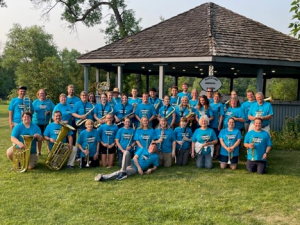 Wahpeton Community Band - about 40 people with matching turquoise shirts, holding their instruments