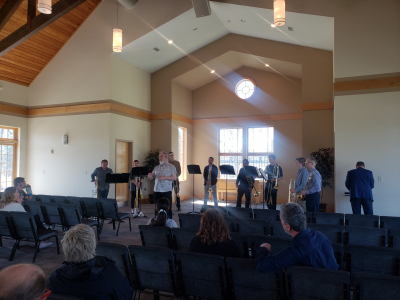 Composer Chris Gable standing with ND Trombone Choir on UND campus