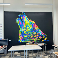 large abstract, colorful wolf head painted on a black background
