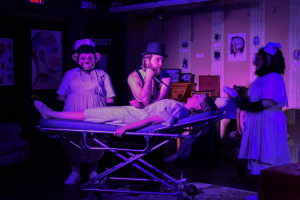 Four actors on a stage performing in Retail Therapy, a play about mental health hospitals by Kathleen Coudle-King; photo by Michael Bogert