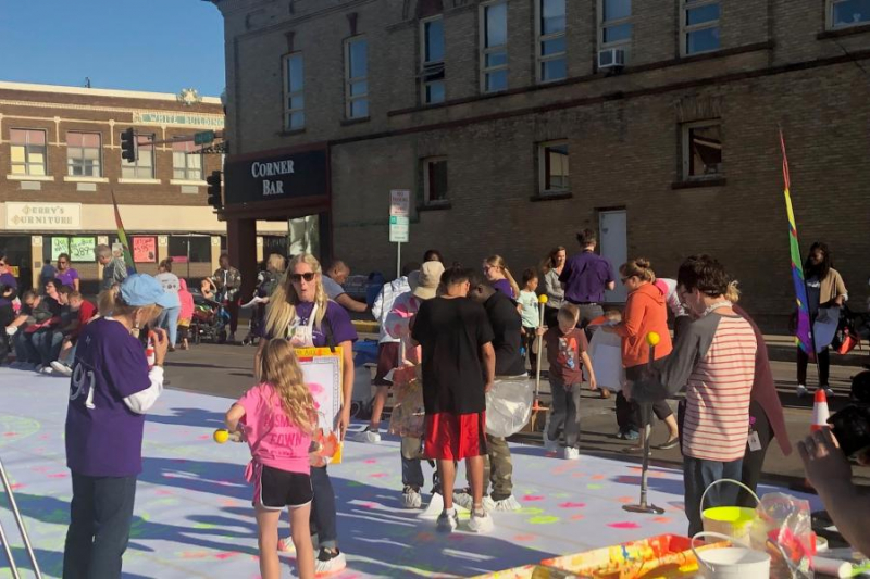 Photo of Zot Artz program and people participating in art activities outside in Jamestown